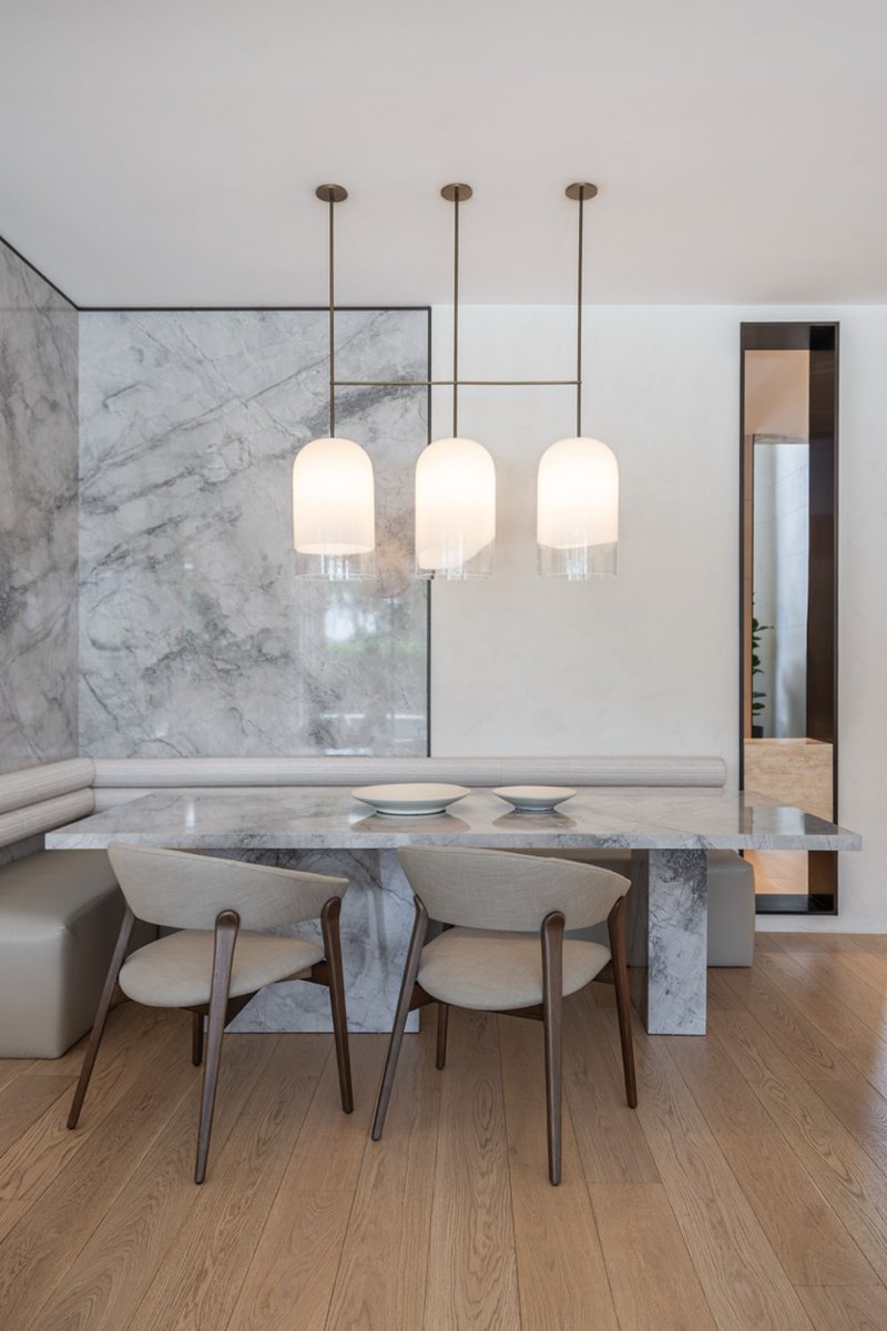 wood and porcelain interplay across curved interiors in florida renovation