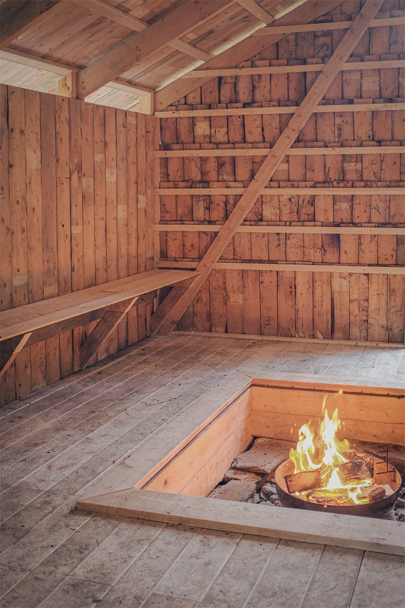 student collective builds fireplace shelter from reclaimed materials in northern norway