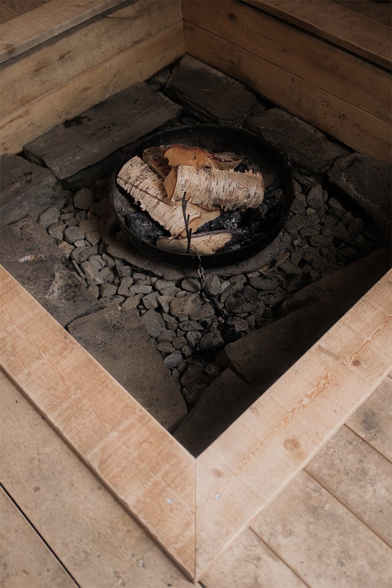 student collective builds fireplace shelter from reclaimed materials in northern norway