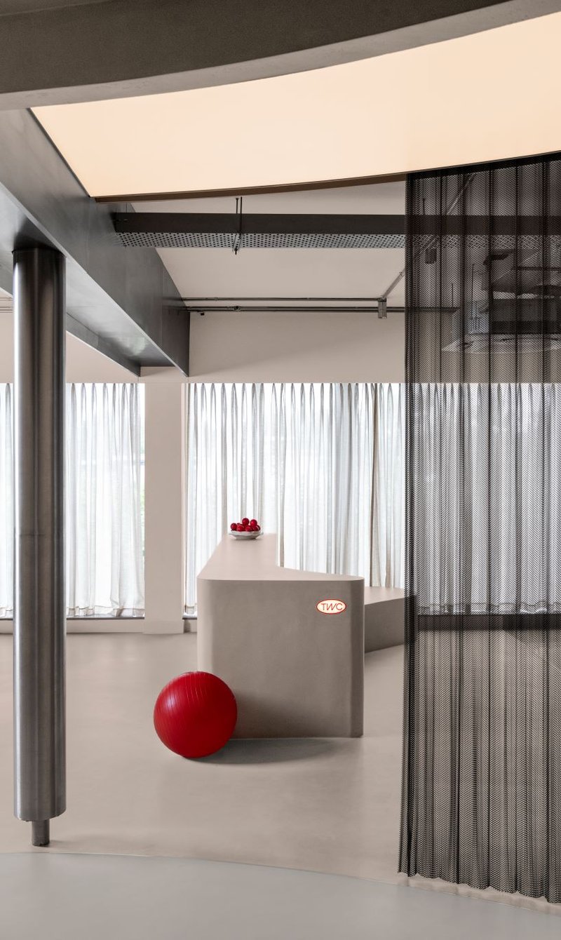 concrete and steel textures shape showroom in india organized as a continuous loop