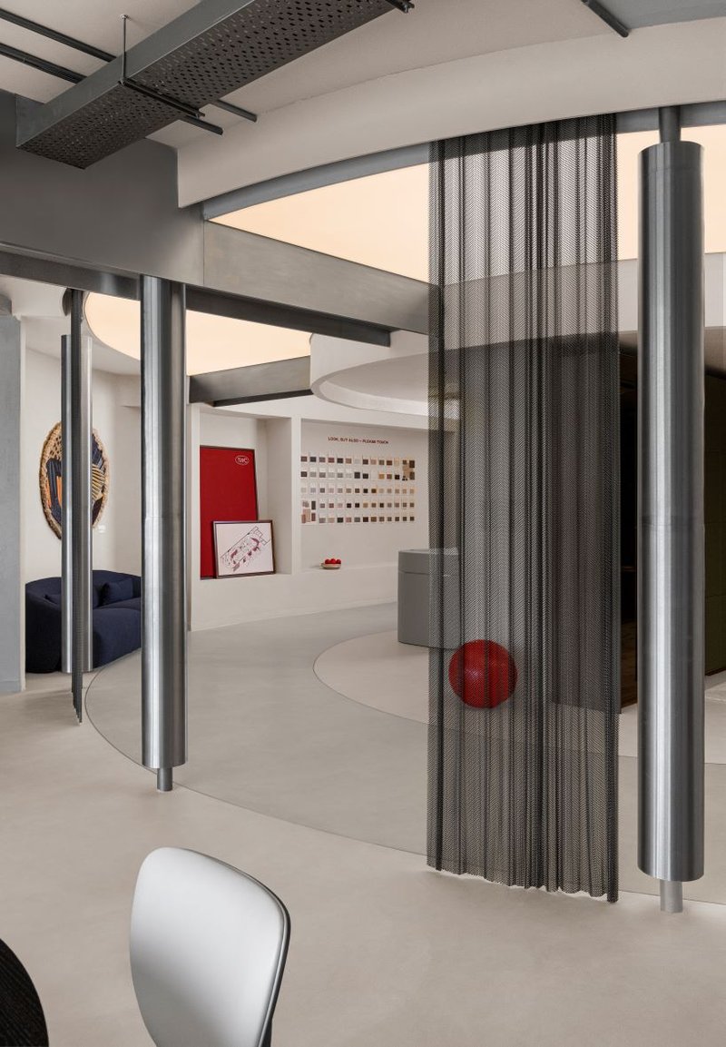 concrete and steel textures shape showroom in india organized as a continuous loop